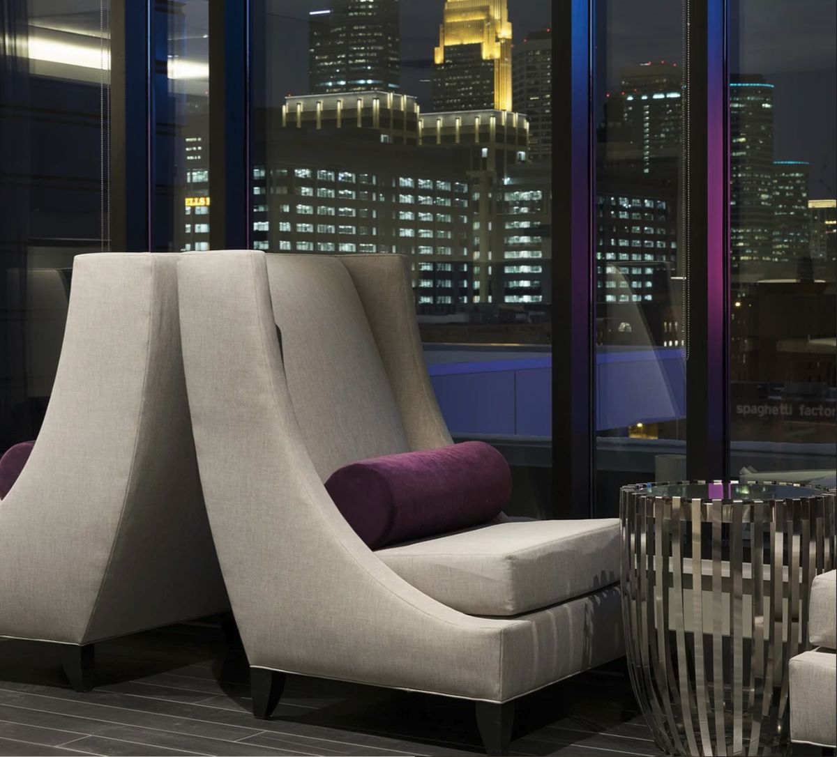 Lounge chairs facing the city at night