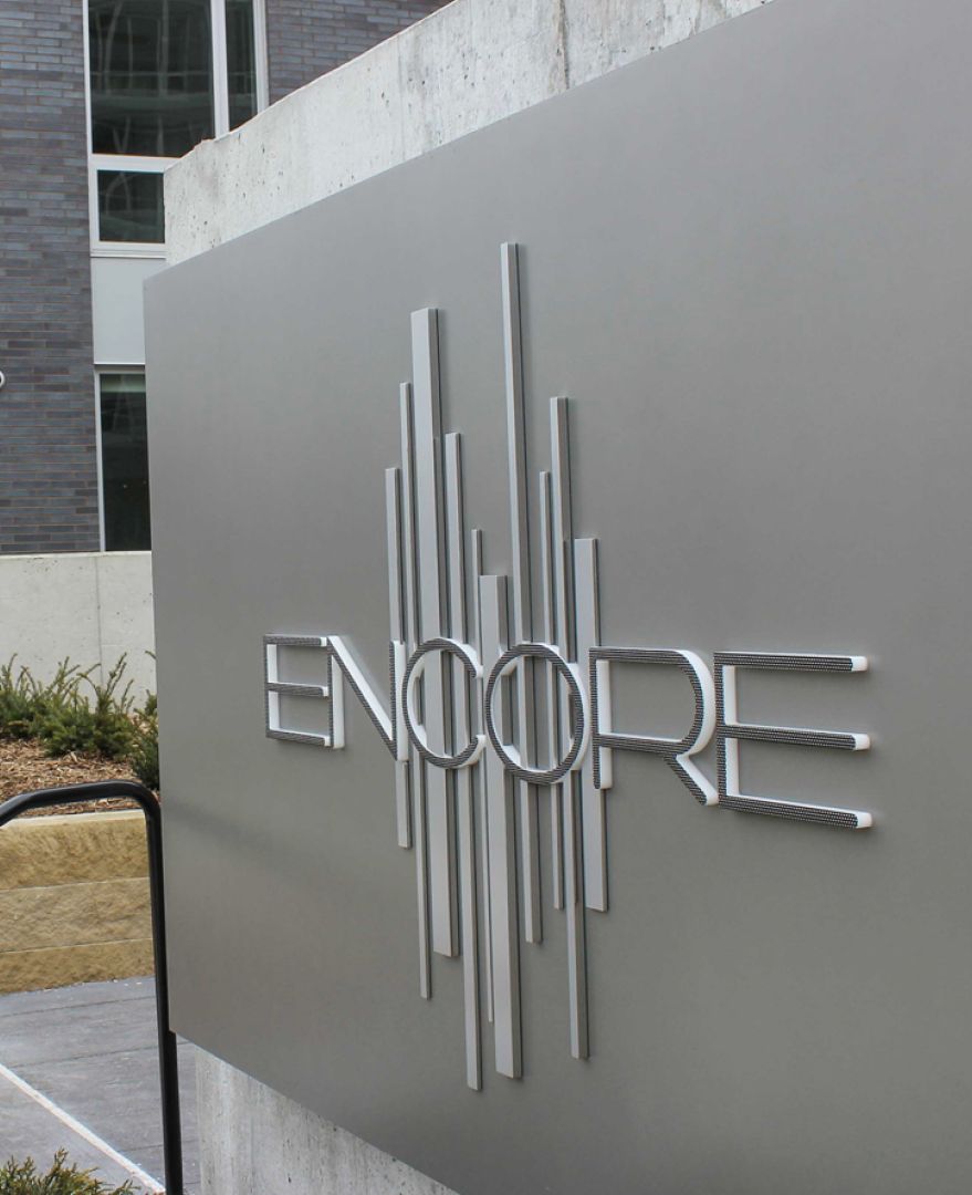 The Encore logo on a stone wall