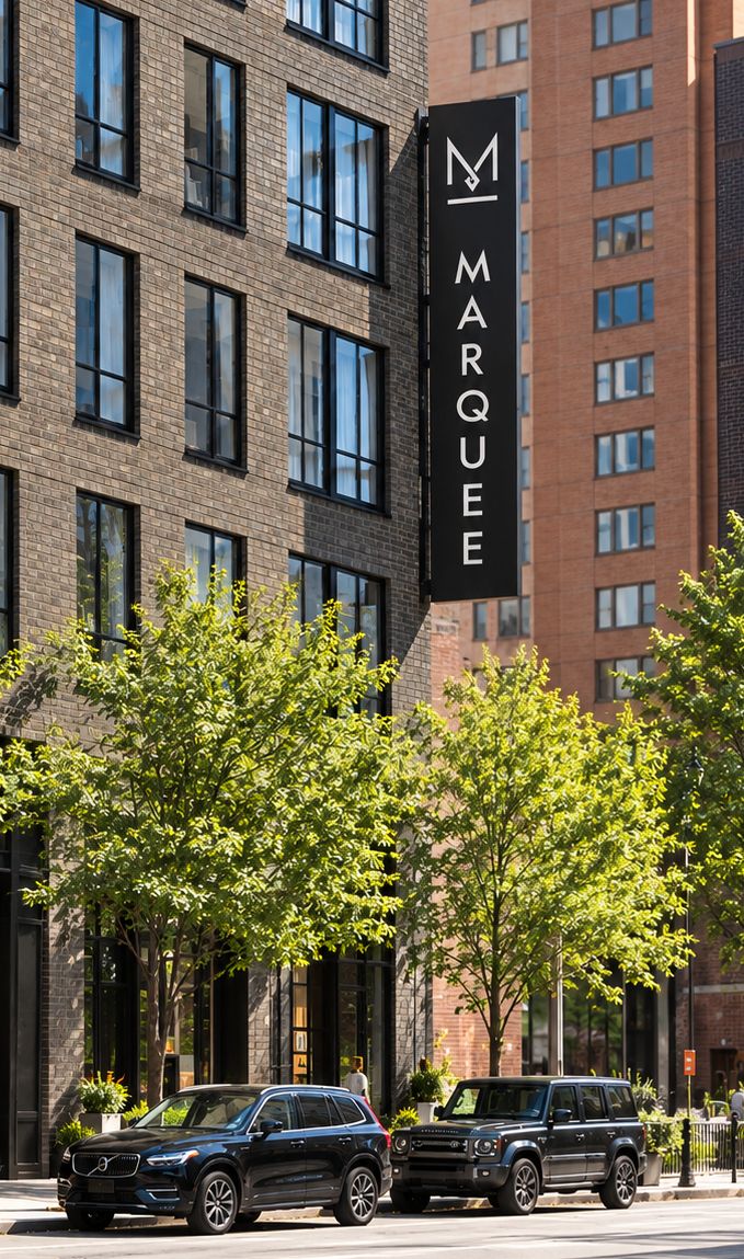 A tall Marquee sign on the side of the building