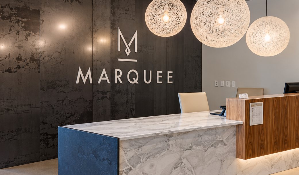 The Marquee logo on the lobby wall behind the front desk