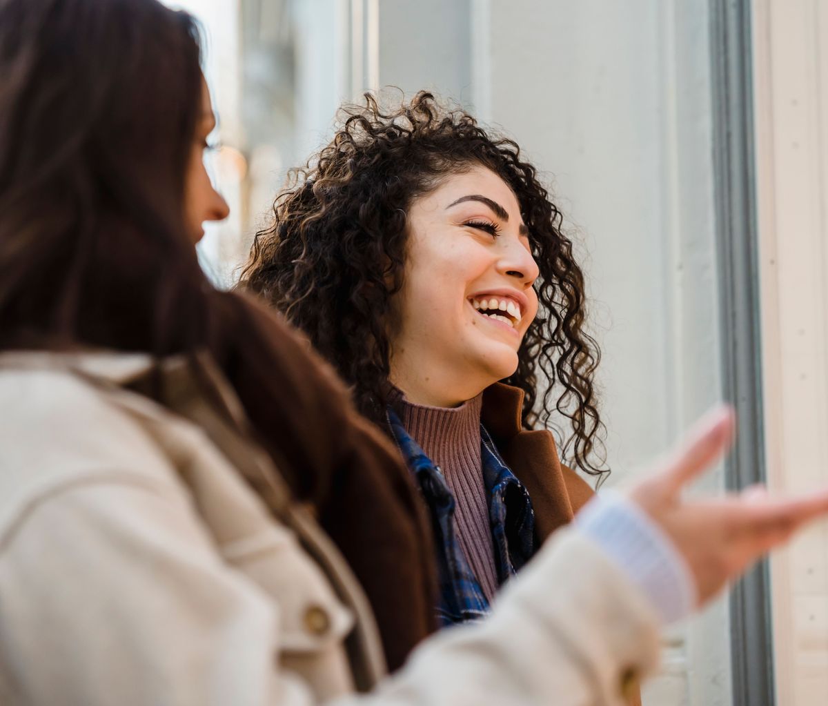 A smiling resident talking with a friend