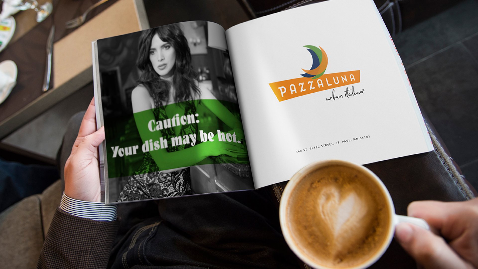 An open magazine with a Pazzaluna ad, Caution: Your dish may be hot, next to a cappuccino