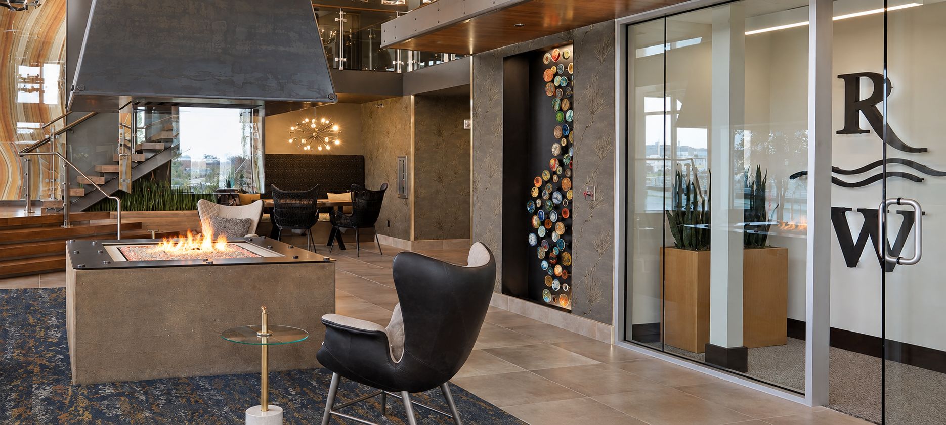 The Riverwalk lobby with a fireplace and the RW logo on the glass