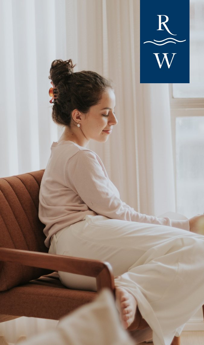 A resident relaxing at home, with the Riverwalk logo
