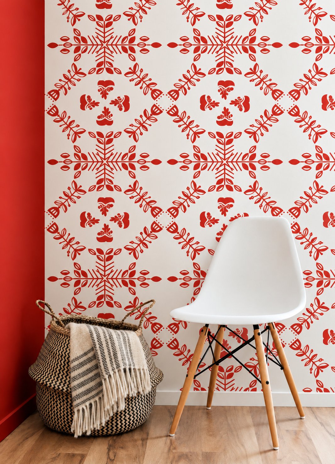 Red Scandihoo pattern wallpaper behind a white chair and a woven basket