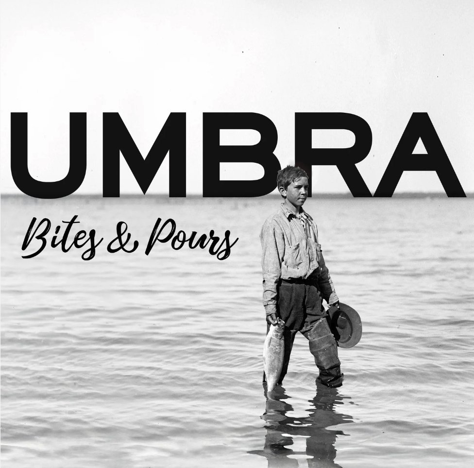 The Umbra Bites & Pours logo over an old photo of a boy wading in a lake