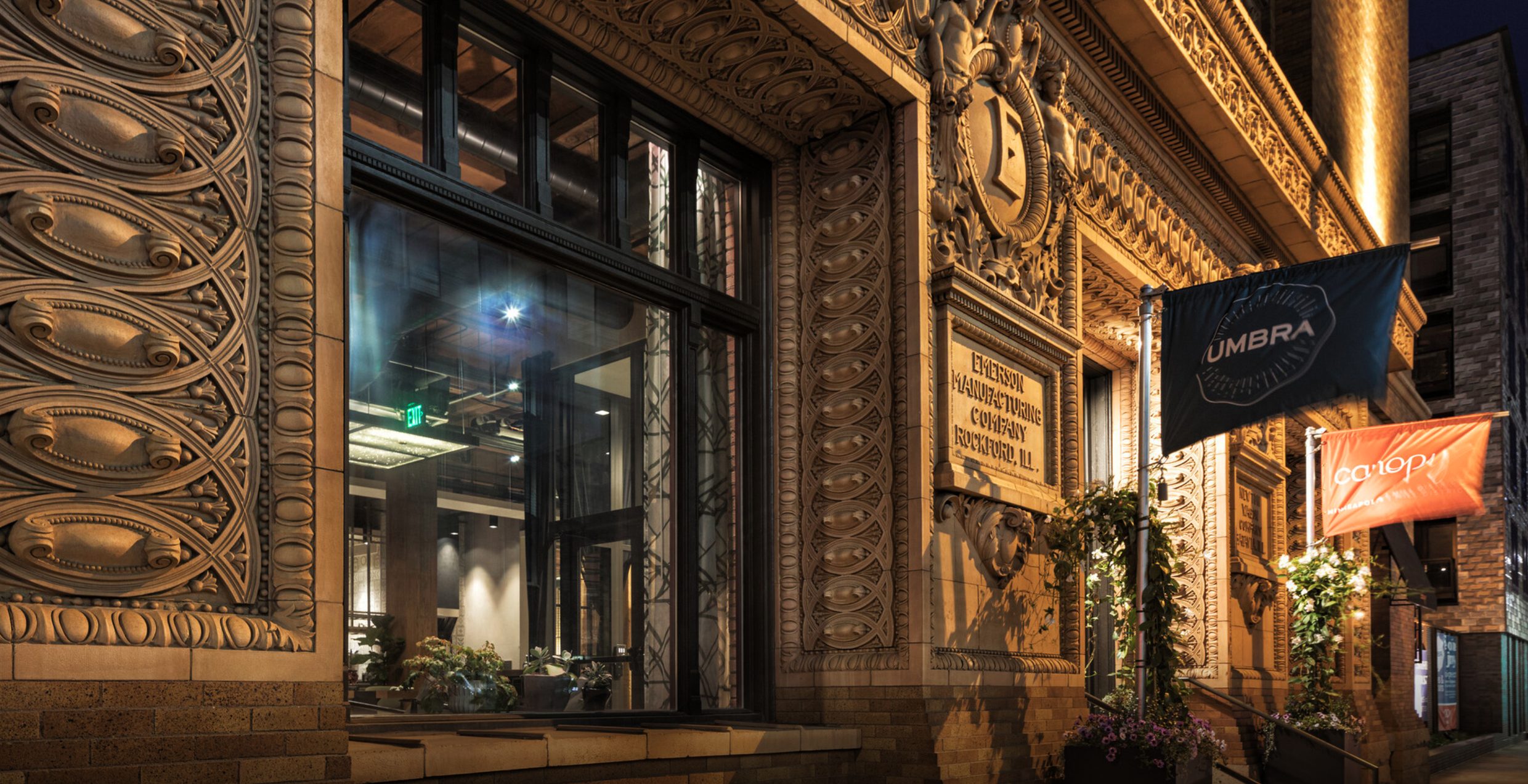 The Umbra flag outside the hotel’s carved stone entrance at night