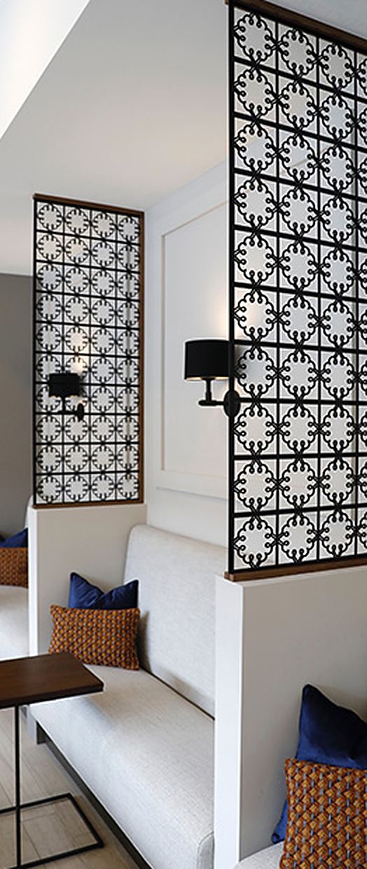 Custom ironwork room dividers beside a bench seat